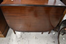 A reproduction Regency style mahogany gateleg table having fluted legs