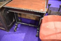 A Victorian side or games table having barley twist frame work oak carved top and inner drawer