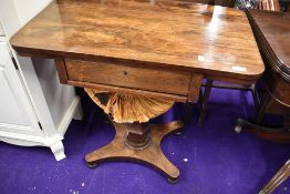 A mid Victorian rosewood sewing or craft table having pedestal base with double under drawer