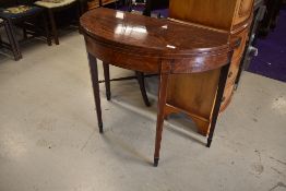 A 19th Century fold out demilune console/tea table having tapered legs with flame mahogany veneer
