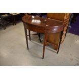 A 19th Century fold out demilune console/tea table having tapered legs with flame mahogany veneer