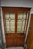 A nice quality reproduction bookcase/display cabinet with cupboard under (some glass damaged hence