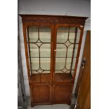 A nice quality reproduction bookcase/display cabinet with cupboard under (some glass damaged hence