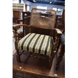 An early 20th Century oak low seat carver chair having bergere style canework back (af) and woolwork