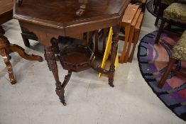 A Victorian mahogany occasional table having octagonal top and galleried undertier
