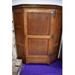 A Victorian oak hall robe, of canted form, in the Arts and Crafts style with cornice detailing,