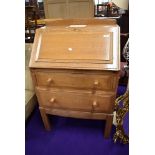 A 1930s Arts and Crafts style golden oak bureau, made at Brynmawr factory of Jim Forrester, designed