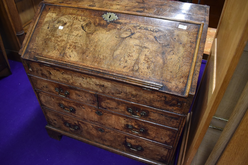 A Georgian burr wood bureau, having ledge to flap. Concealed interior compartment and three long