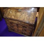 A Georgian burr wood bureau, having ledge to flap. Concealed interior compartment and three long