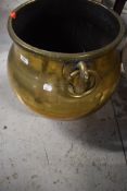 A traditional large brass cauldron, having animalistic/bird ring handles, Eastern design