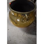 A traditional large brass cauldron, having animalistic/bird ring handles, Eastern design