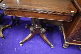 An early 19th Century mahogany framed card or games table with fold out swivel top