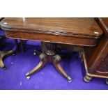 An early 19th Century mahogany framed card or games table with fold out swivel top