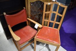 A light oak carver chair having red leather upholstery and a similar lattice back dining chair