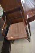 A Victorian carver chair having bow arms on turned frame stretchers