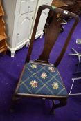 An antique dining chair with mahogany frame on cabriole legs