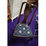 An antique dining chair with mahogany frame on cabriole legs