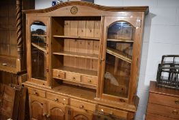 A natural pine kitchen dresser having glazed display top, width approx. 183cm