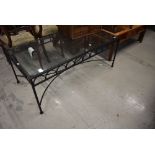 A wrought iron framed coffee table having glass top