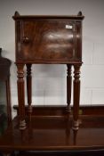 A 19th Century part flame mahogany bedside pot cupboard on fluted legs