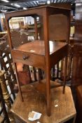 A Victorian mahogany washstand with typical holes to top for wash bowl and beakers and undershelf