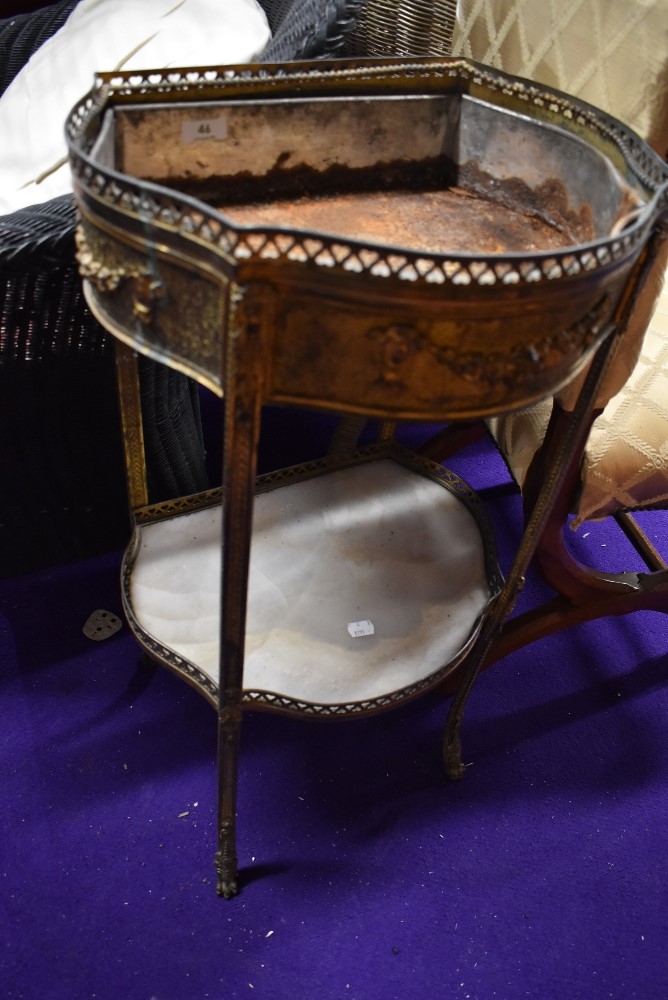 A Regency style heavy brass and ormolu plant stand having animal paw feet and marble shelf