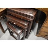 An Oriental hardwood nest of three tables