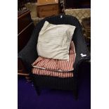 A woven fibre conservatory tub chair