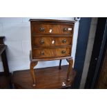 A Reprodux reproduction bedside chest of three drawers on stand