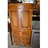 A modern yew wood cocktail cabinet having double cupboard and internal light