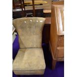 A vintage nursing chair with moquette style upholstery on stained frame