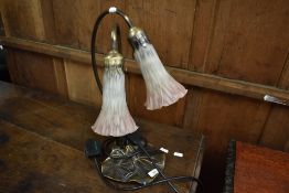 A side lamp in the form of a lily having glass trumpet style shades