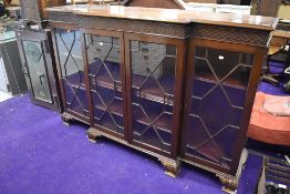 An early 20th century display cabinet having triple fronted beaded and glazed doors