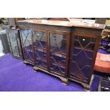 An early 20th century display cabinet having triple fronted beaded and glazed doors