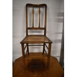 A bedroom chair having oak frame with woven seat