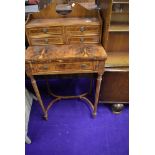 A regency style ladies parlour desk having flame veneer fold out desk on tapered legs