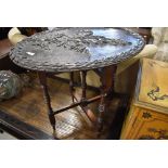 A 19th Century occasional table having naturalistic poker work and carved oval top on folding turned