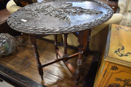 A 19th Century occasional table having naturalistic poker work and carved oval top on folding turned