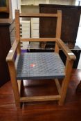 A small sized child's beech wood framed arm chair