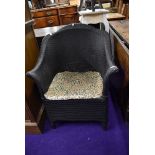 A woven fibre conservatory tub chair having shaped seat