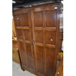 An early 20th Century oak wardrobe having panelled doors