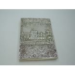 A Georgian silver castle top card case of rectangular form having a raised repousse scene of Windsor