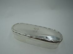 An Edwardian oval silver trinket box having crimped rim to hinged lid bearing monogram G, Birmingham