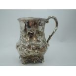 A Victorian silver Christening mug of baluster form having repousse floral, scroll and