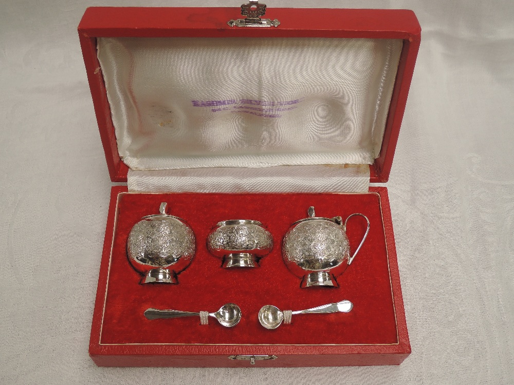 A cased Pakistani silver three piece cruet set of traditional Asian form, retailed by Kashmir Silver