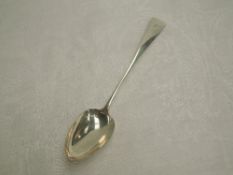 A Georgian silver basting spoon of Old English form bearing monogram to terminal, London 1815,