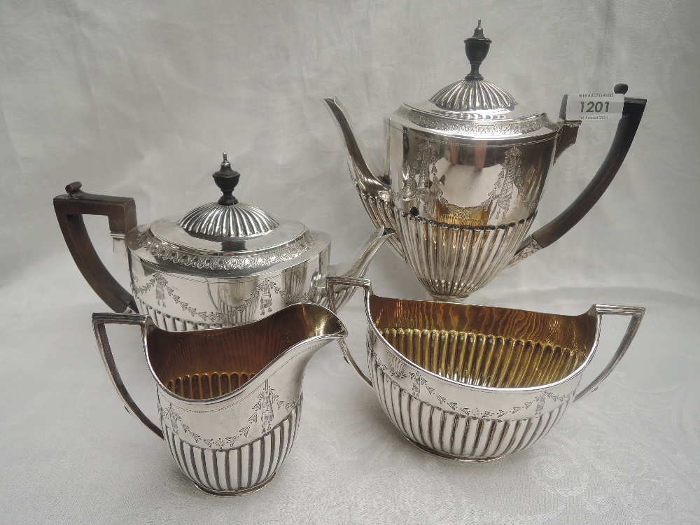 A Victorian silver four piece tea and coffee set having half gadrooned bodies with engraved swag