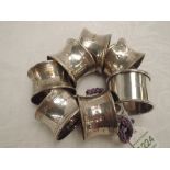A set of six silver napkin rings of plain form, Birmingham 1945, (1 AF), and a white metal napkin