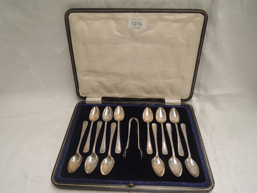 A cased set of twelve silver teaspoons with matching sugar nips having moulded decoration, Sheffield - Image 2 of 2