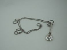 A silver napkin clip of plain form, Birmingham 2009, A J Poole, on a silver chain